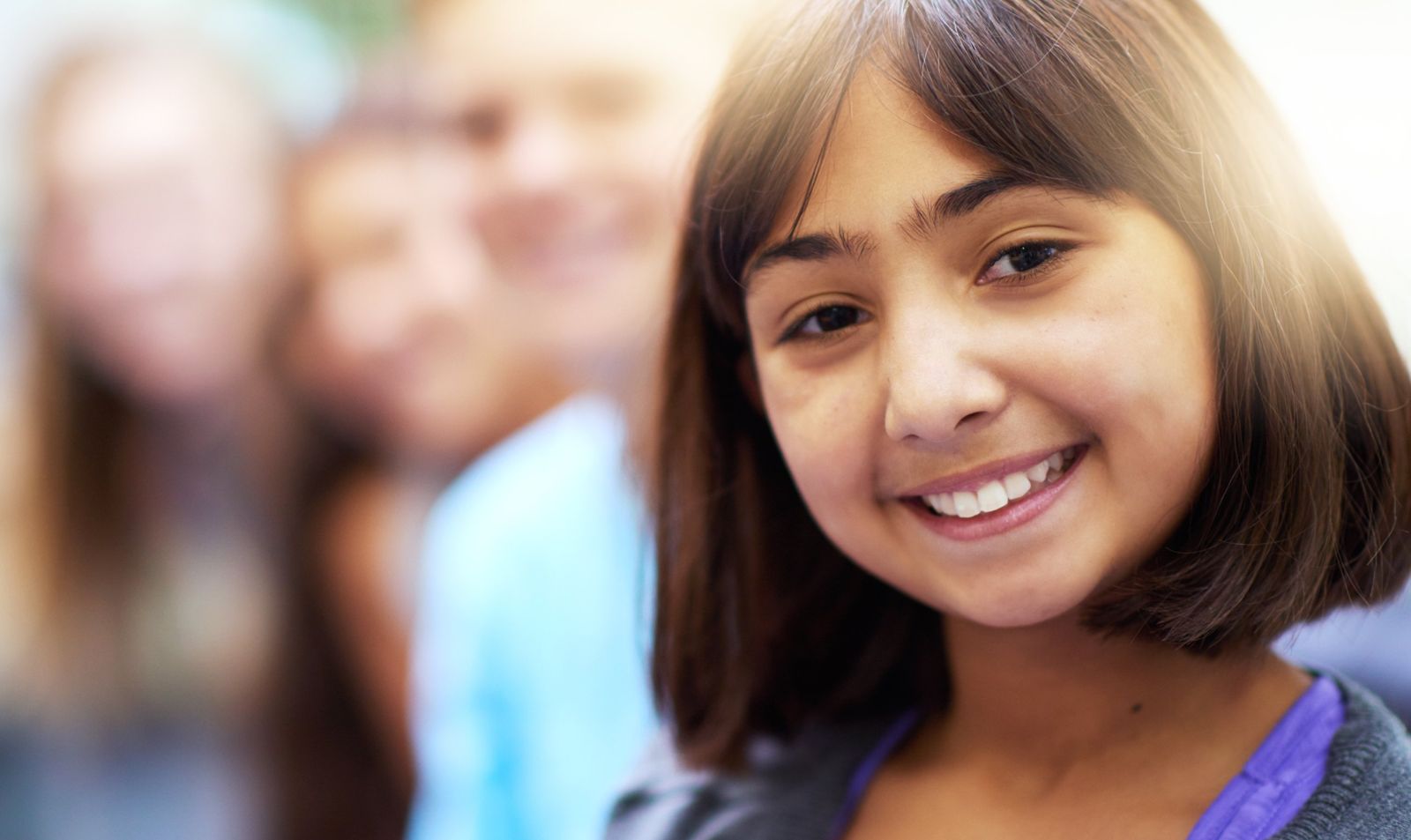 A smiling girl with a bob haircut