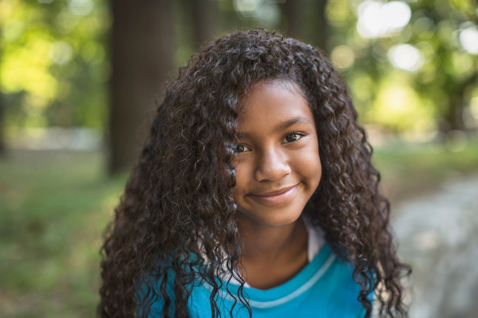 A smiling girl with long curly hair